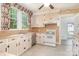 Kitchen featuring tile backsplash, white appliances, light cabinets, and a stainless steel dishwasher at 330 S Ellis St, Salisbury, NC 28144