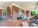 Covered porch with brick columns, tiled floor, and comfortable seating at 330 S Ellis St, Salisbury, NC 28144