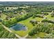 Extensive aerial view showcases a pond and pool amidst a vast landscape of scattered homes and dense woodlands at 3381 Elaine Ave, Lincolnton, NC 28092