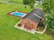 A captivating aerial view showcasing the home's backyard pool, patio deck and brick exterior at 3381 Elaine Ave, Lincolnton, NC 28092