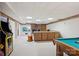 Finished basement featuring a large seating area, pool table, exposed brick fireplace and classic arcade game at 3381 Elaine Ave, Lincolnton, NC 28092