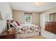Bedroom featuring a floral bedspread, wooden furniture and a window view of the pool at 3381 Elaine Ave, Lincolnton, NC 28092