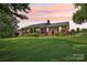 Sprawling brick ranch home with a lush, landscaped front yard and a covered front porch at 3381 Elaine Ave, Lincolnton, NC 28092