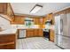 Well-lit kitchen with oak cabinets, stainless steel appliances and white tile flooring at 3381 Elaine Ave, Lincolnton, NC 28092
