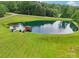 Aerial view of pond with dock and house surrounded by lush green landscaping at 3381 Elaine Ave, Lincolnton, NC 28092