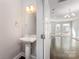 Chic half-bathroom featuring a pedestal sink, modern fixtures, and a clean design, conveniently located near the living area at 3643 Vallette Ct, Charlotte, NC 28203