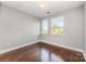 Bright bedroom features hardwood floors, neutral paint, and two windows offering lots of natural light at 3643 Vallette Ct, Charlotte, NC 28203