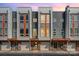 Modern townhome exterior featuring brick accents, multiple windows, and individual garages in a contemporary design at 3643 Vallette Ct, Charlotte, NC 28203