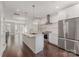 Stylish kitchen with stainless steel appliances, a center island, white cabinetry, and hardwood floors, ideal for cooking at 3643 Vallette Ct, Charlotte, NC 28203