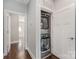 Convenient laundry area with a stacked washer and dryer, neatly tucked away behind a door, maximizing space efficiency at 3643 Vallette Ct, Charlotte, NC 28203
