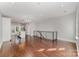 Open-concept living area with hardwood floors, modern railing, and natural light, perfect for entertaining and relaxation at 3643 Vallette Ct, Charlotte, NC 28203