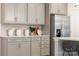 Bright kitchen featuring light gray cabinets, stainless steel refrigerator, and stylish backsplash at 4715 Formation Dr # 047, Lancaster, SC 29720
