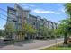 Apartment building with modern facade, enhanced by tree-lined street, offering a blend of nature and urban lifestyle at 514 W 10Th St # 302, Charlotte, NC 28202