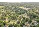 Expansive aerial view of a neighborhood surrounded by lush greenery and mature trees at 5323 Snow White Ln, Charlotte, NC 28213