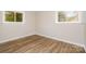 This bedroom features hardwood floors and two windows providing ample natural light at 5323 Snow White Ln, Charlotte, NC 28213