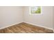 This cozy bedroom features hardwood floors and a window providing natural light at 5323 Snow White Ln, Charlotte, NC 28213