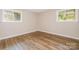 Bright bedroom with wood-look flooring and two windows for natural light at 5323 Snow White Ln, Charlotte, NC 28213