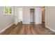 Bedroom featuring wood-look flooring, closet, bathroom access, and lots of light at 5323 Snow White Ln, Charlotte, NC 28213