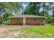 The home has a simple backyard with green grass at 5323 Snow White Ln, Charlotte, NC 28213