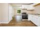 Spacious kitchen features white cabinets and a stainless steel range at 5323 Snow White Ln, Charlotte, NC 28213