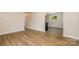Well lit living room with wood-look laminate flooring and neutral wall colors at 5323 Snow White Ln, Charlotte, NC 28213