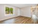 Clean living room featuring laminate flooring, a front door, and a large window at 5323 Snow White Ln, Charlotte, NC 28213