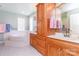 Large bathroom with soaking tub, double vanity, and blue walls at 544 Hicks Creek Rd, Troutman, NC 28166