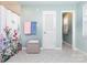 Bright bathroom featuring floral shower curtain, linen closet, and tiled floor at 544 Hicks Creek Rd, Troutman, NC 28166