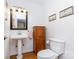 Charming powder room featuring a pedestal sink, wood accents, and decorative wall art at 544 Hicks Creek Rd, Troutman, NC 28166