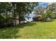 Exterior view of home with a detached garage on a grassy, gently sloping lot at 544 Hicks Creek Rd, Troutman, NC 28166