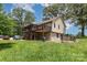 Exterior view of home showing screened porch, deck, stone foundation, and spacious yard with mature trees at 544 Hicks Creek Rd, Troutman, NC 28166