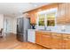 Eat-in kitchen featuring stainless steel refrigerator, oak cabinets, and white appliances at 544 Hicks Creek Rd, Troutman, NC 28166