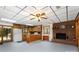 Open kitchen with wood cabinets, island countertop, and brick fireplace at 544 Hicks Creek Rd, Troutman, NC 28166