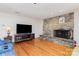 Spacious living room featuring a stone fireplace, hardwood floors, a large TV, and recessed lighting at 544 Hicks Creek Rd, Troutman, NC 28166