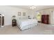 Bright main bedroom with neutral carpet, large bed, and a view to the outside at 544 Hicks Creek Rd, Troutman, NC 28166