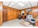 Home office with wood paneled walls and built-in shelving, desk, and storage at 544 Hicks Creek Rd, Troutman, NC 28166