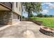 Spacious concrete patio featuring a stone fire pit and partial stone perimeter wall, ideal for outdoor entertaining at 544 Hicks Creek Rd, Troutman, NC 28166