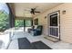 Inviting screened porch featuring comfortable seating, ceiling fan and natural light at 544 Hicks Creek Rd, Troutman, NC 28166