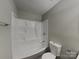Bathroom with a combined bathtub and shower, accompanied by a toilet at 6513 Old Post Rd, Charlotte, NC 28212