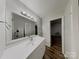 Well-lit bathroom featuring a modern vanity with a large mirror and contemporary fixtures, providing a relaxing space at 6513 Old Post Rd, Charlotte, NC 28212
