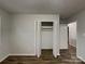 Neutral bedroom featuring a closet and wood-look laminate flooring at 6513 Old Post Rd, Charlotte, NC 28212