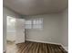 Comfortable bedroom with wood-look floors and a door to the ensuite bath, offering privacy and convenience at 6513 Old Post Rd, Charlotte, NC 28212
