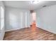Bedroom with hardwood flooring, natural light, closet, and view to hall at 6513 Old Post Rd, Charlotte, NC 28212