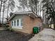 Brick home showcasing multi-pane windows and tasteful exterior paint at 6513 Old Post Rd, Charlotte, NC 28212