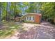 A charming single-story brick home features a well-manicured lawn and a long driveway surrounded by mature trees at 6513 Old Post Rd, Charlotte, NC 28212