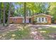 Charming single-story brick home with mature trees and a well-maintained front yard at 6513 Old Post Rd, Charlotte, NC 28212
