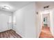 Hallway with a white front door and a view to another room and wood-look floors at 6513 Old Post Rd, Charlotte, NC 28212