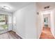 Entryway hallway view featuring wood-look floors and natural light from the glass door at 6513 Old Post Rd, Charlotte, NC 28212