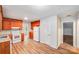 Bright kitchen features wood cabinets, laminate countertops, white appliances, and wood-look floors at 6513 Old Post Rd, Charlotte, NC 28212