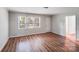 Living room features light wood floors, neutral walls, and natural light from windows at 6513 Old Post Rd, Charlotte, NC 28212